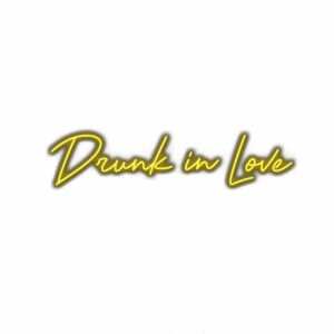 Neon sign text 'Drunk in Love' with shadow on white background.