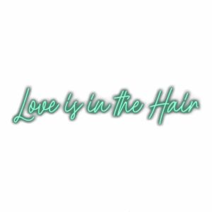 Neon sign text "Love is in the Hair