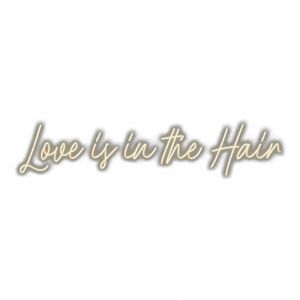 Cursive text "Love is in the Hair" wall art.