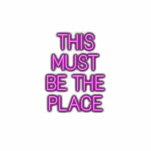 Neon-style text "THIS MUST BE THE PLACE" on white.