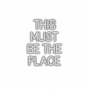 Inspirational quote "This Must Be The Place" in white.