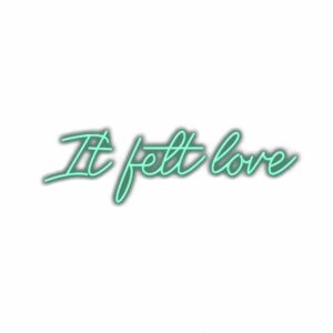 Neon sign text "It felt love" with shadow.
