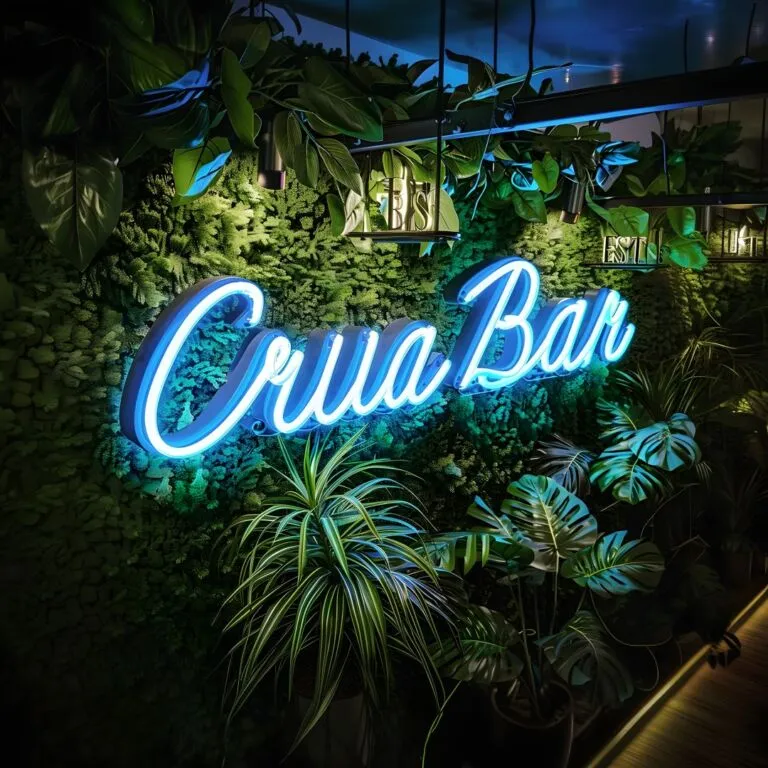 Neon sign reading "Crua Bar" mounted on a lush green plant wall with hanging potted plants and additional greenery in the foreground.